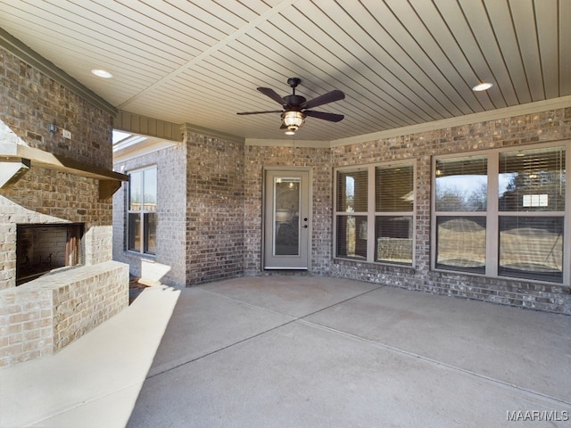 view of patio / terrace featuring an outdoor brick fireplace and ceiling fan