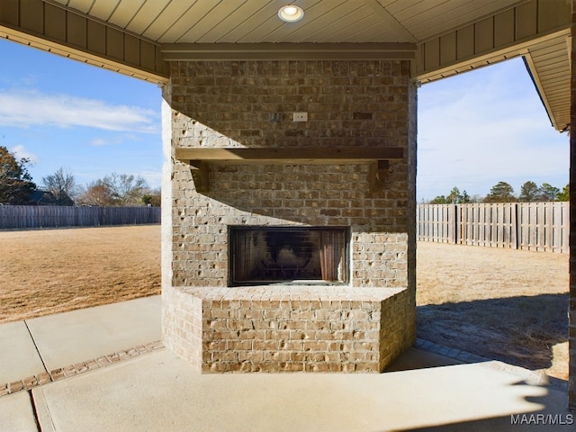 view of patio / terrace featuring an outdoor brick fireplace