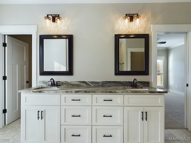 bathroom featuring crown molding and vanity