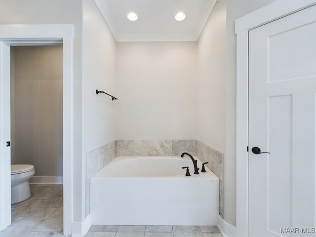 bathroom with crown molding, toilet, a bathing tub, and tile patterned flooring