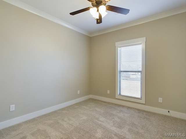 carpeted empty room featuring ceiling fan and crown molding