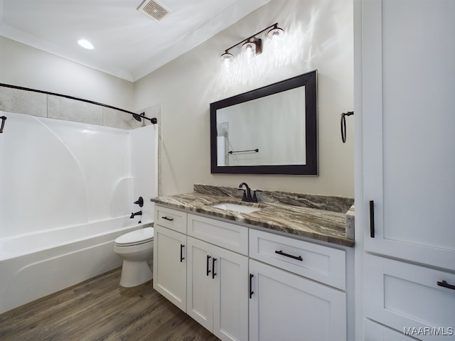 full bathroom with hardwood / wood-style flooring, toilet, bathtub / shower combination, and vanity