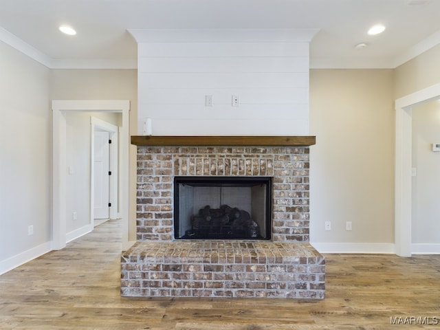 interior details featuring hardwood / wood-style floors, crown molding, and a fireplace