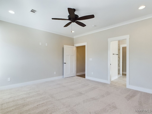 carpeted spare room featuring crown molding and ceiling fan