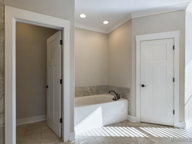 bathroom with tile patterned floors, a bathtub, and ornamental molding