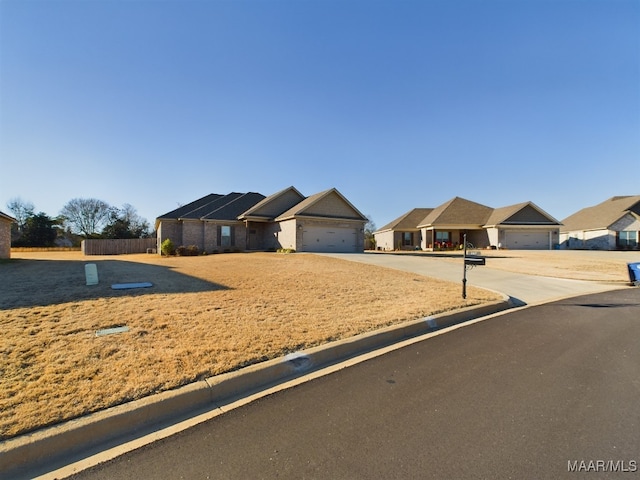 ranch-style home featuring a garage and solar panels