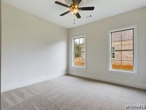 carpeted empty room featuring a ceiling fan and baseboards