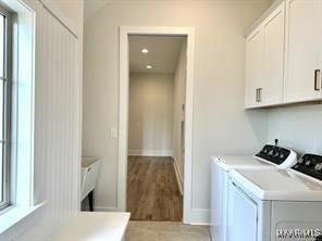 laundry area featuring recessed lighting, cabinet space, baseboards, and separate washer and dryer