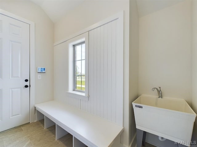 mudroom featuring lofted ceiling and a sink