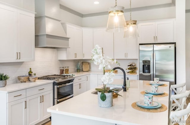 8319 Young Xing, Montgomery, AL 36116 - kitchen featuring appliances with stainless steel finishes, custom range hood, light countertops, white cabinets, and recessed lighting