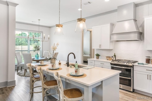8319 Young Xing, Montgomery, AL 36116 - kitchen featuring double oven range, custom range hood, backsplash, light countertops, and recessed lighting