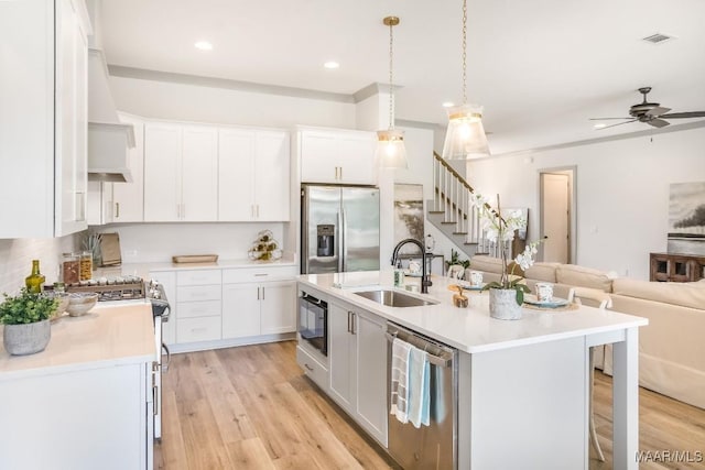 8319 Young Xing, Montgomery, AL 36116 - kitchen featuring stainless steel appliances, open floor plan, light countertops, an island with sink, and white cabinets