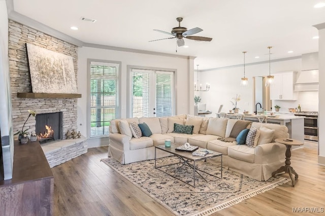 8319 Young Xing, Montgomery, AL 36116 - living room with ceiling fan, light wood finished floors, a fireplace, recessed lighting, and ornamental molding