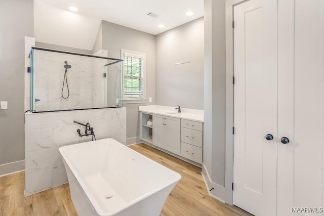 8319 Young Xing, Montgomery, AL 36116 - bathroom with a marble finish shower, a freestanding bath, wood finished floors, recessed lighting, and vanity
