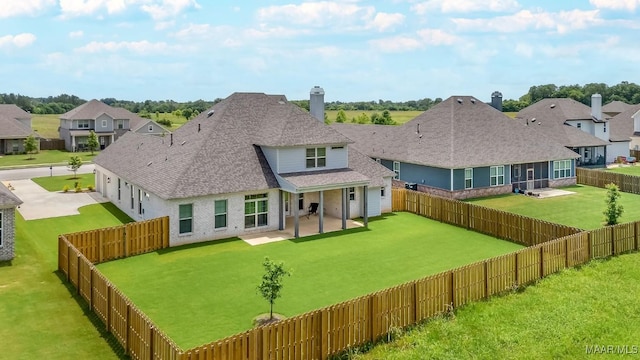8319 Young Xing, Montgomery, AL 36116 - back of house with concrete driveway, a fenced backyard, a shingled roof, a patio, and a residential view
