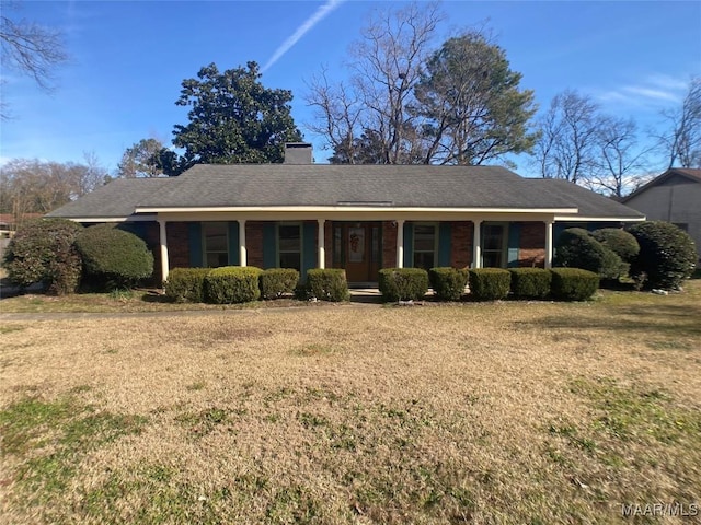 ranch-style home with a porch and a front yard