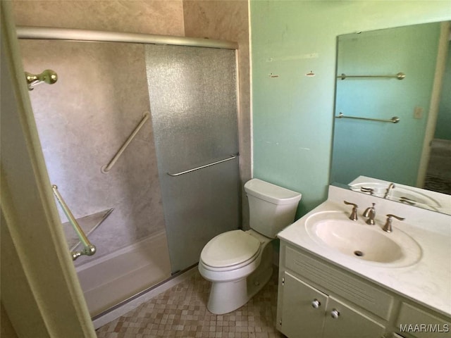 bathroom featuring vanity, toilet, and a shower with door