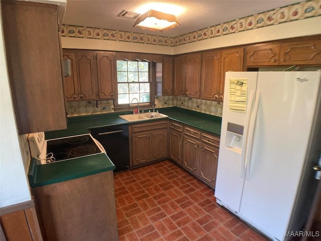 kitchen featuring range with electric cooktop, dishwasher, a textured ceiling, white refrigerator with ice dispenser, and sink