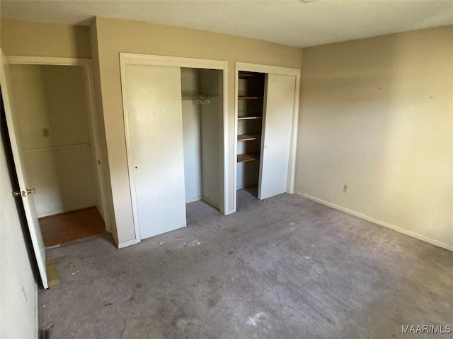 unfurnished bedroom with multiple closets