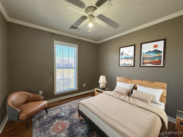 bedroom featuring ceiling fan, a textured ceiling, dark hardwood / wood-style floors, and crown molding