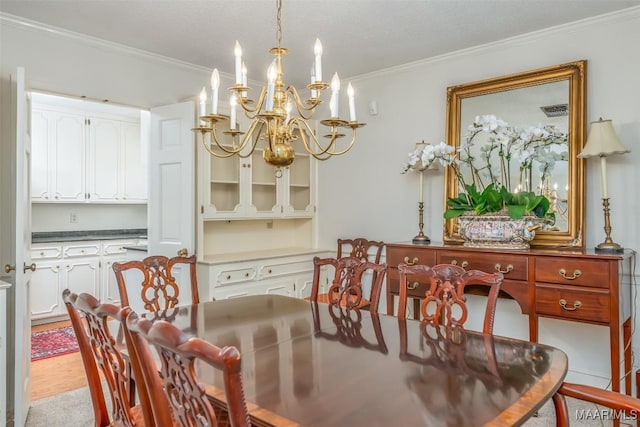 dining space featuring crown molding and a chandelier