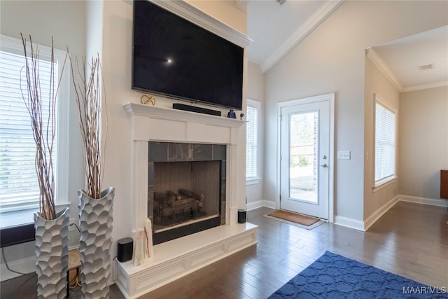 living room with vaulted ceiling, dark wood-type flooring, and crown molding