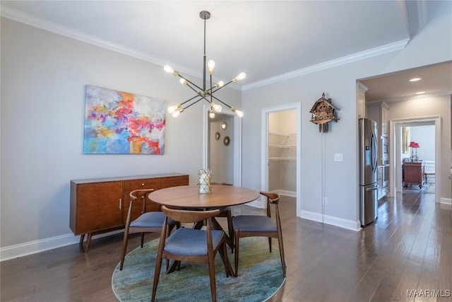 dining room with dark wood-type flooring, a notable chandelier, and crown molding