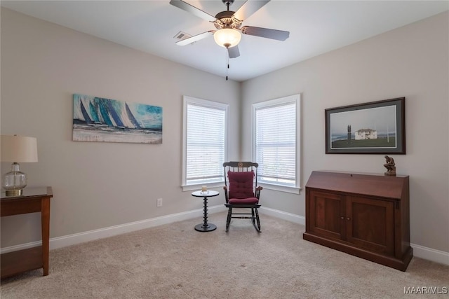 sitting room featuring ceiling fan and light carpet