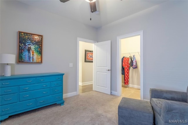 sitting room with ceiling fan and light colored carpet