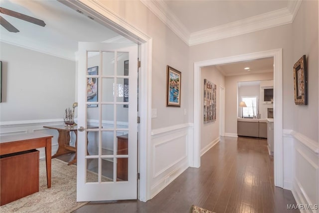 corridor featuring french doors, dark hardwood / wood-style floors, and ornamental molding