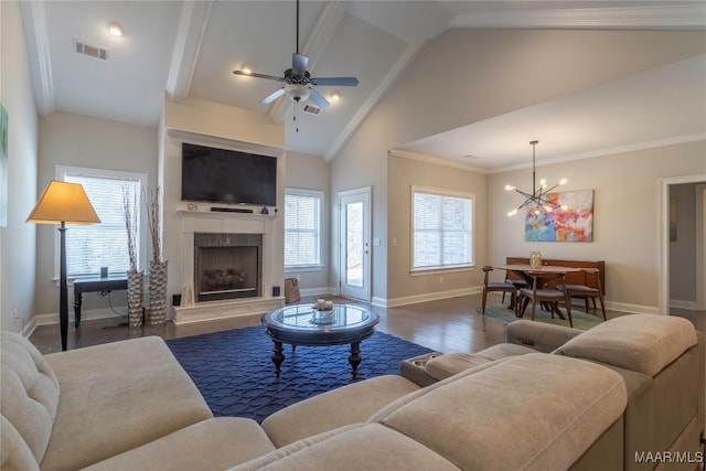 living room with dark hardwood / wood-style flooring, ceiling fan with notable chandelier, high vaulted ceiling, and ornamental molding