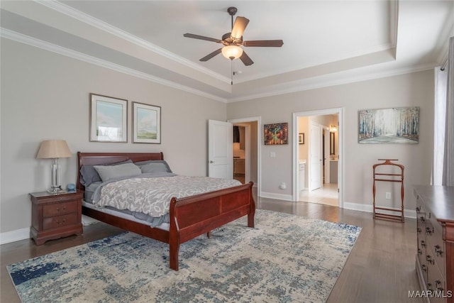 bedroom with ceiling fan, dark hardwood / wood-style flooring, a tray ceiling, and ornamental molding