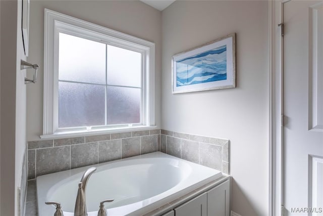 bathroom with a tub to relax in and a wealth of natural light