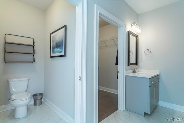 bathroom featuring toilet and vanity