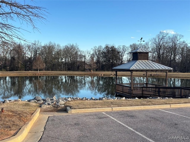 view of dock with a gazebo and a water view