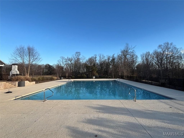 view of swimming pool with a patio