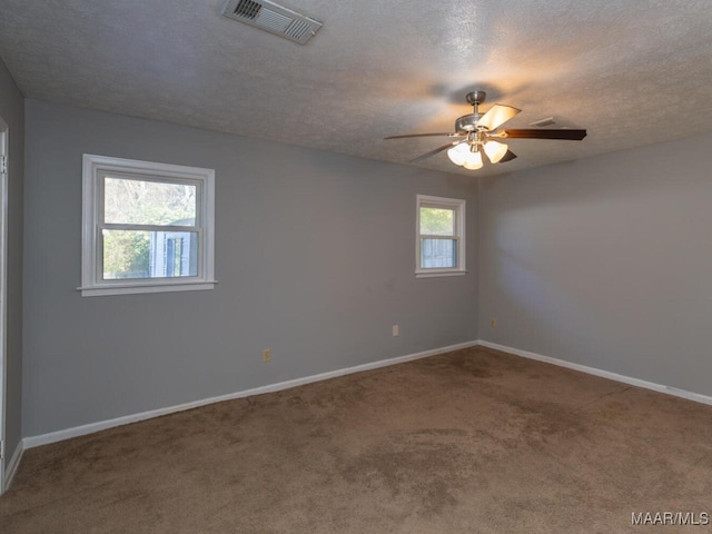 unfurnished room with ceiling fan, carpet flooring, and plenty of natural light