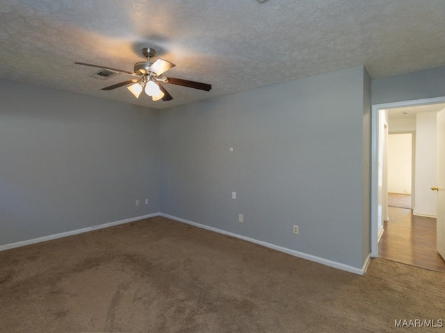 spare room with a textured ceiling, ceiling fan, and carpet flooring