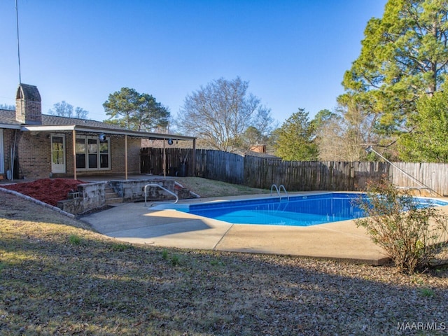 view of swimming pool with a patio