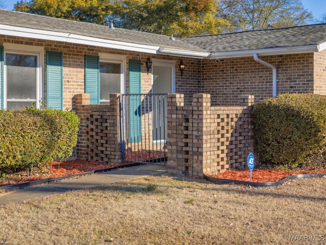 entrance to property with a lawn