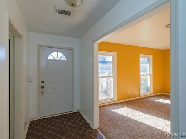 entryway with dark colored carpet