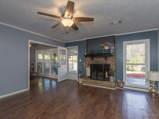 unfurnished living room with a brick fireplace, a textured ceiling, and ornamental molding