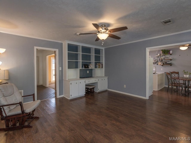 living room featuring ceiling fan, crown molding, built in features, a textured ceiling, and dark hardwood / wood-style flooring