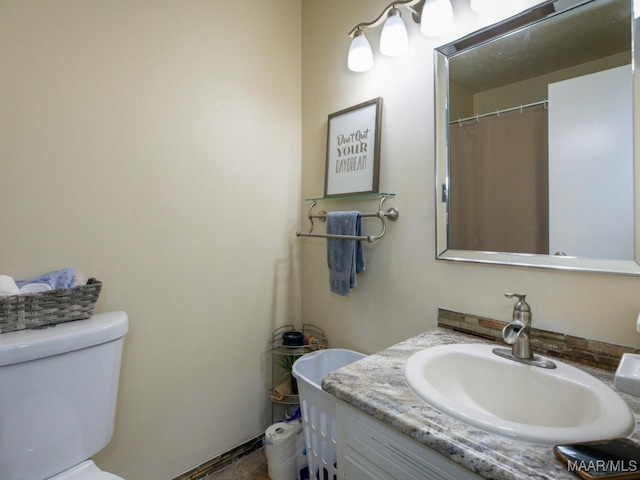 bathroom featuring toilet and vanity