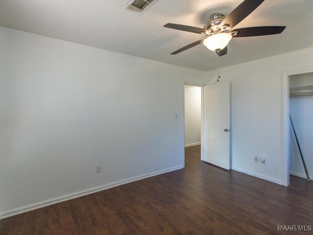 unfurnished bedroom featuring ceiling fan and dark hardwood / wood-style flooring