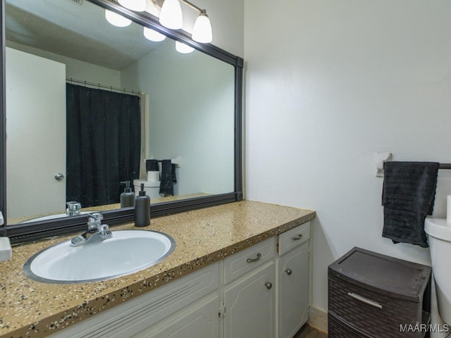 bathroom featuring toilet and vanity