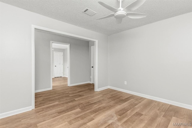 unfurnished room featuring ceiling fan, a textured ceiling, and light hardwood / wood-style floors