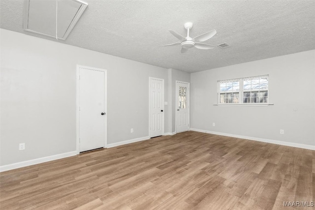 unfurnished room featuring a textured ceiling, ceiling fan, and light hardwood / wood-style floors