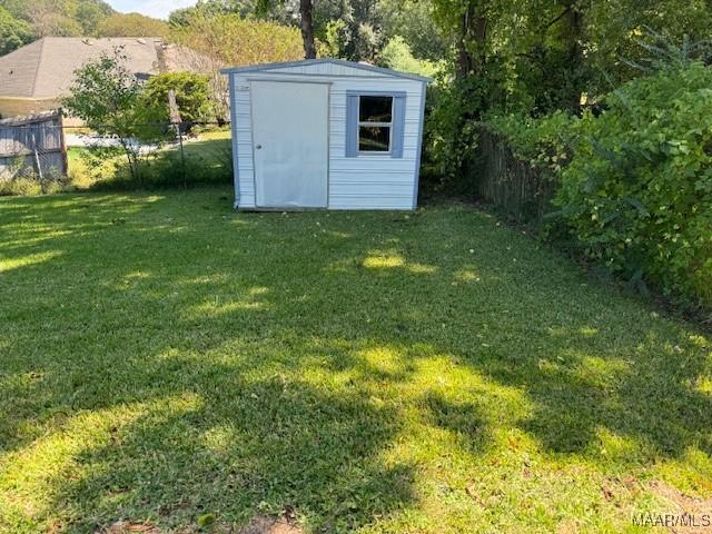 view of outbuilding with a yard