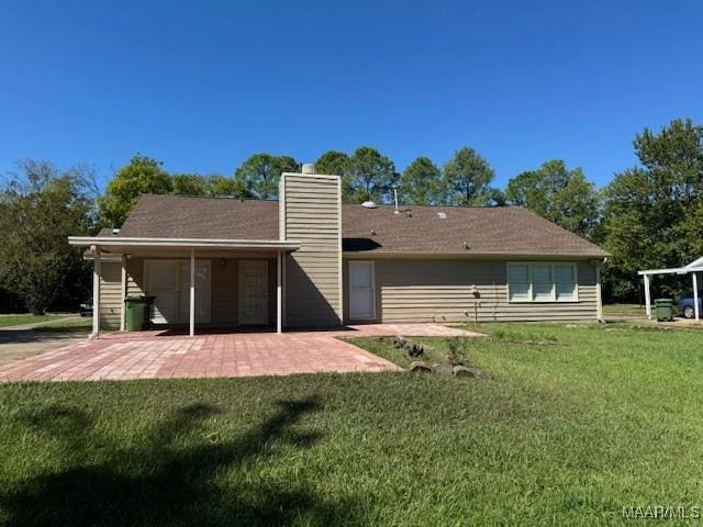 back of house featuring a patio area and a yard